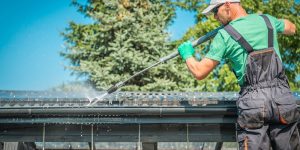 AdobeStock_215815730-cleaning-roof-gutter.jpeg